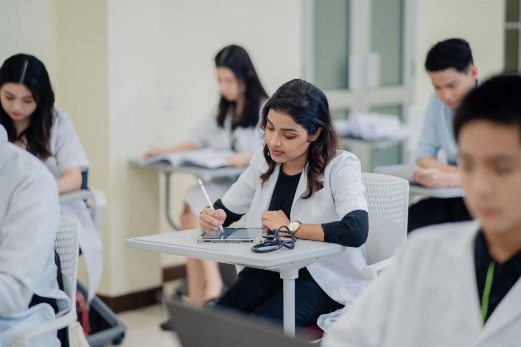 Medicine students writing their notes in a lecture.